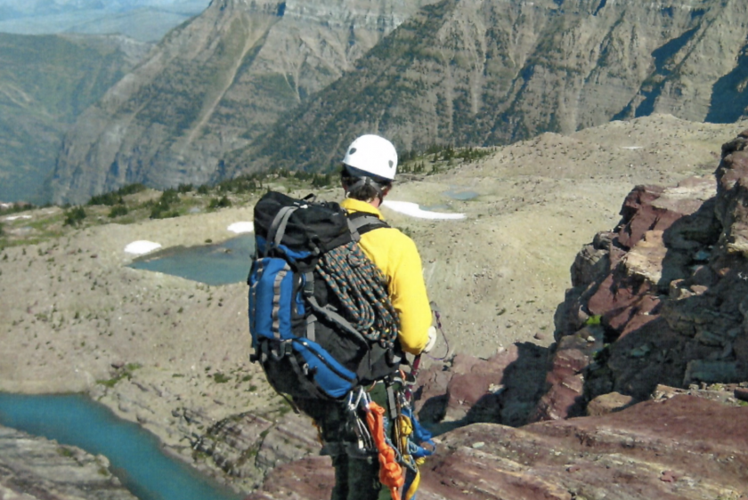 Chuck Cameron, in high-visibility gear and a hard hat, looks out on a basin